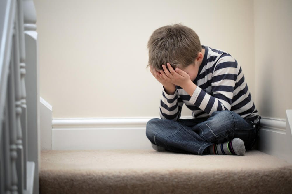 Child crying on staircase
