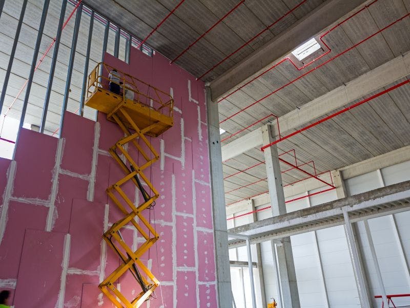 Photo of man working at height on a scissor lift