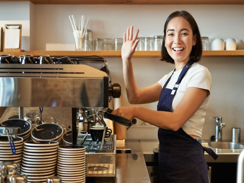 Photo of a young woman working in a coffee shop