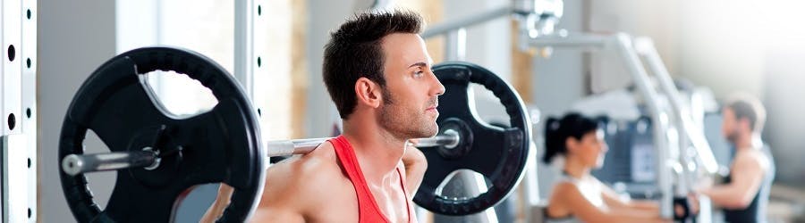 Photo of men and women using gym equipment