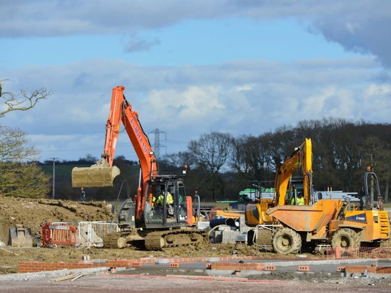 Photo of diggers working on footings for new build houses