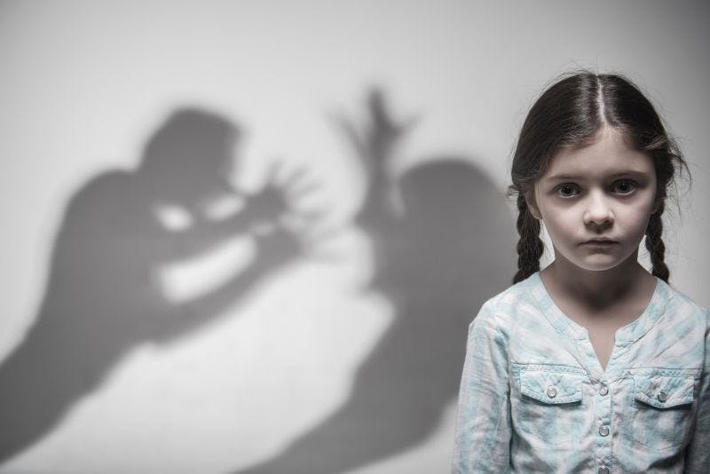 Image of child in front of parent shadows