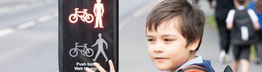 Young boy crossing the road