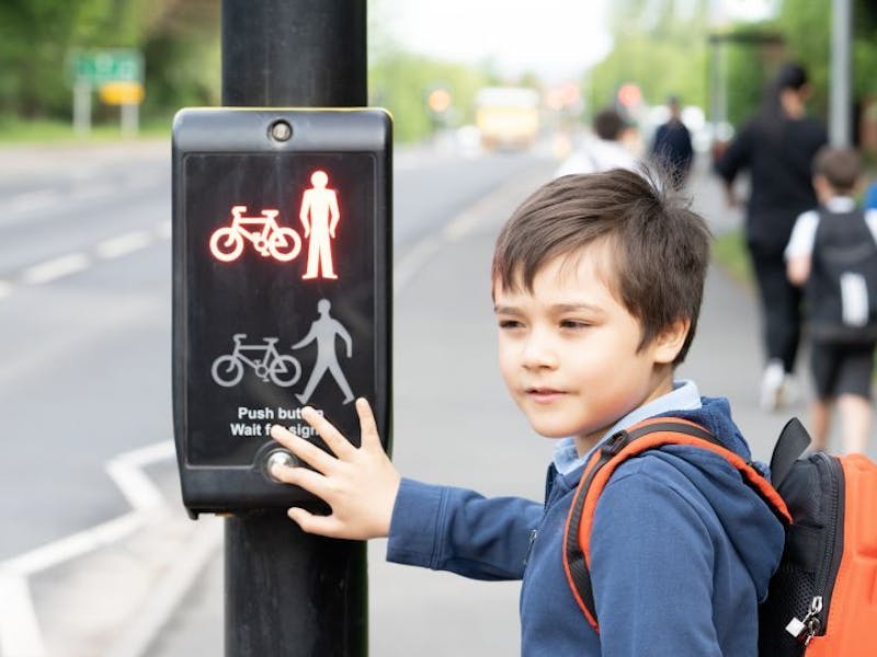 Young boy crossing the road