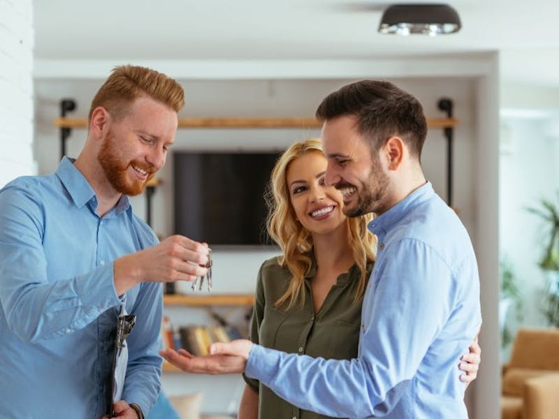 Couple getting keys to a property