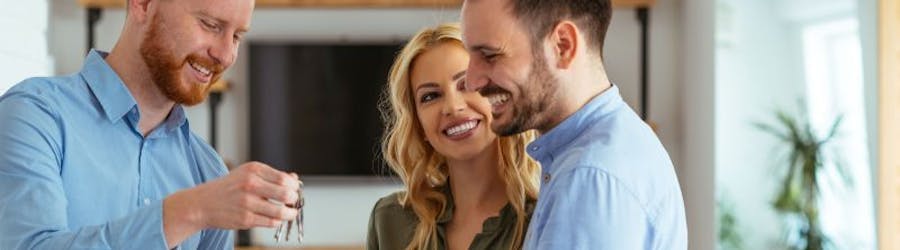 Couple getting keys to a property